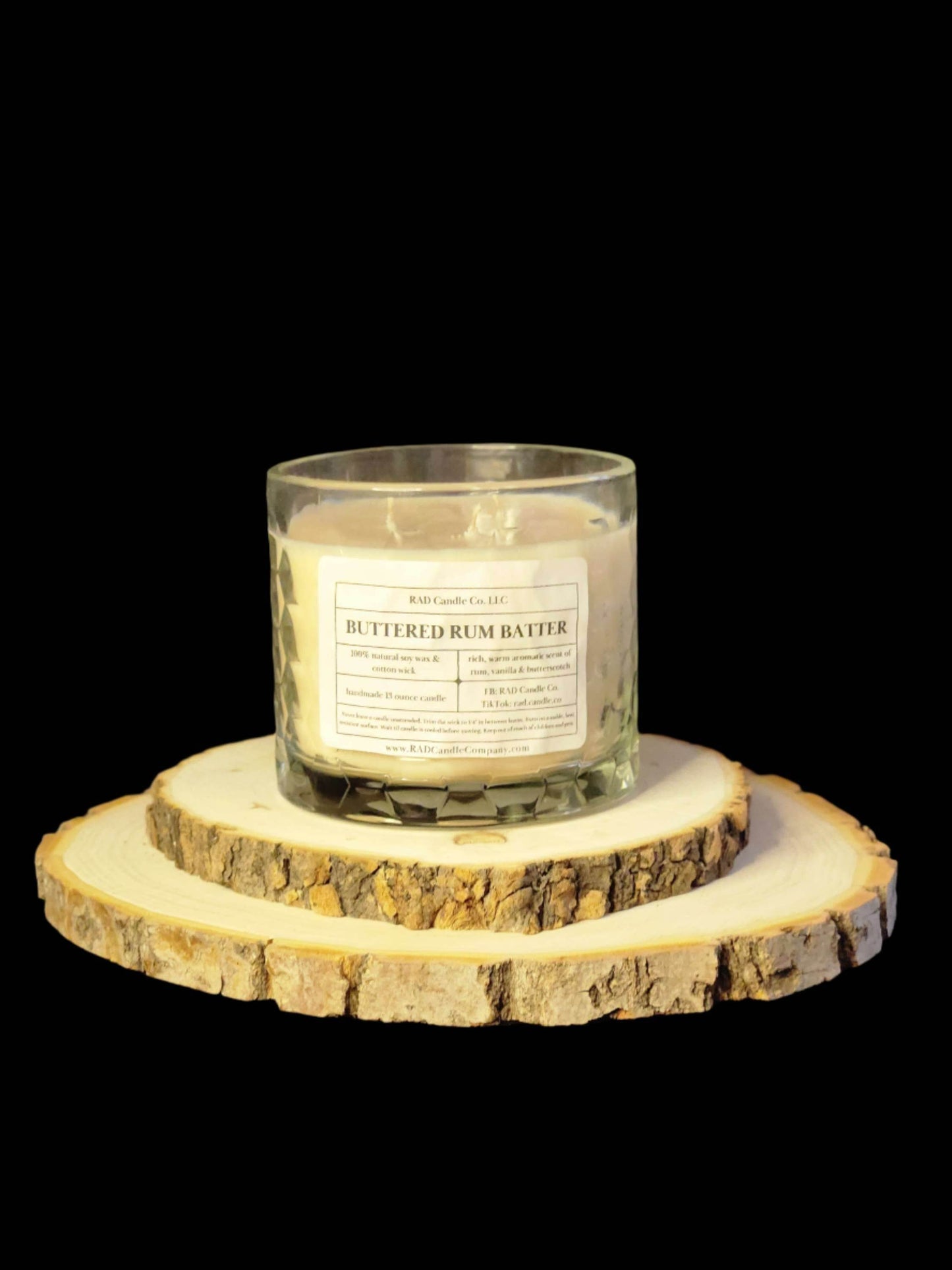 Buttered Rum Scented Soy Candle on wooden coasters, featuring warm vanilla and spice aromas.