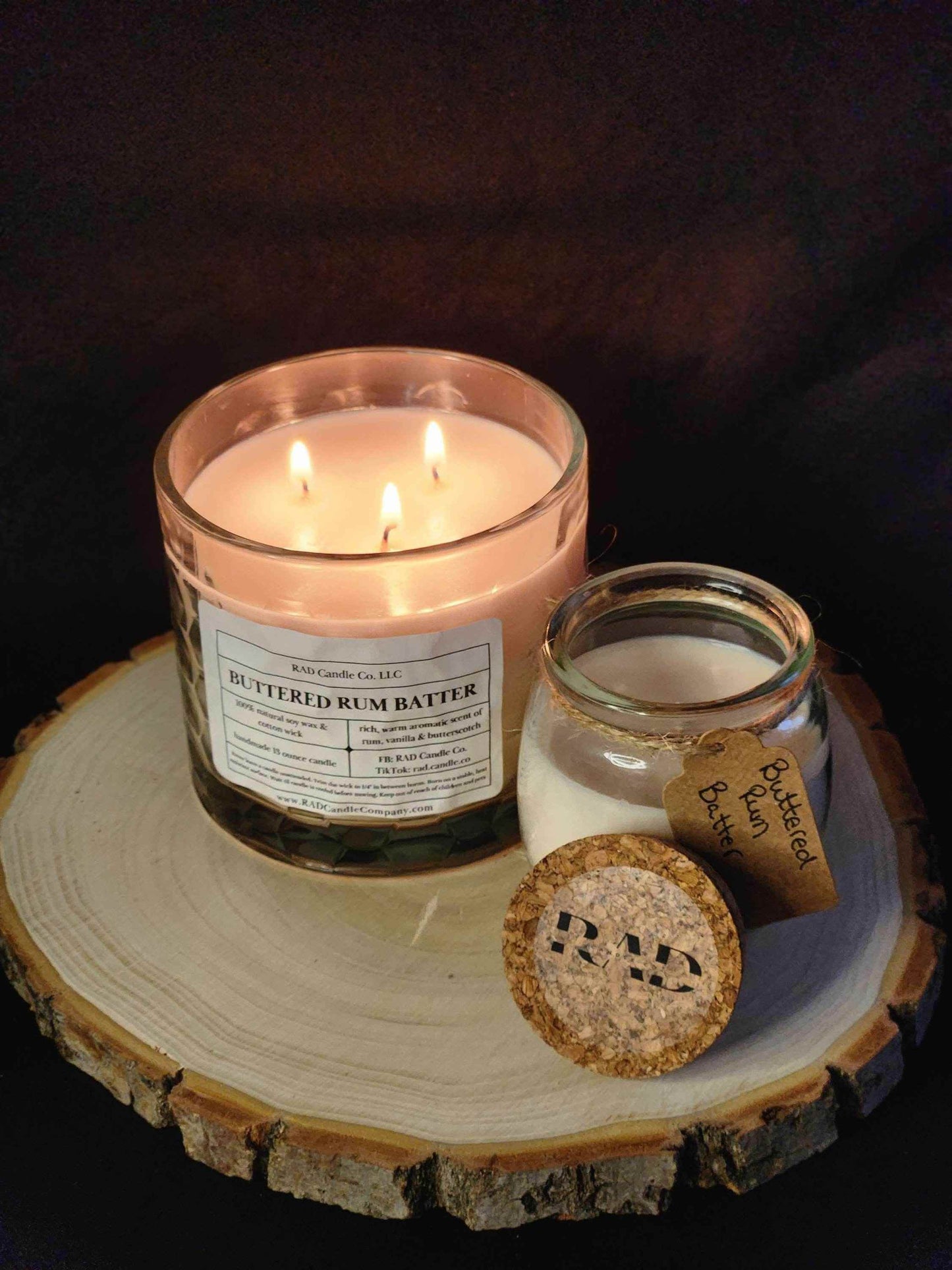 Buttered Rum Batter scented soy candle on wood slice, featuring warm buttered rum, vanilla, and brown sugar aroma.